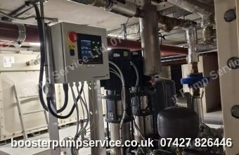 Grundfos booster set control panel and pressure vessel in a basement plant room — circulation pump replacement in London.