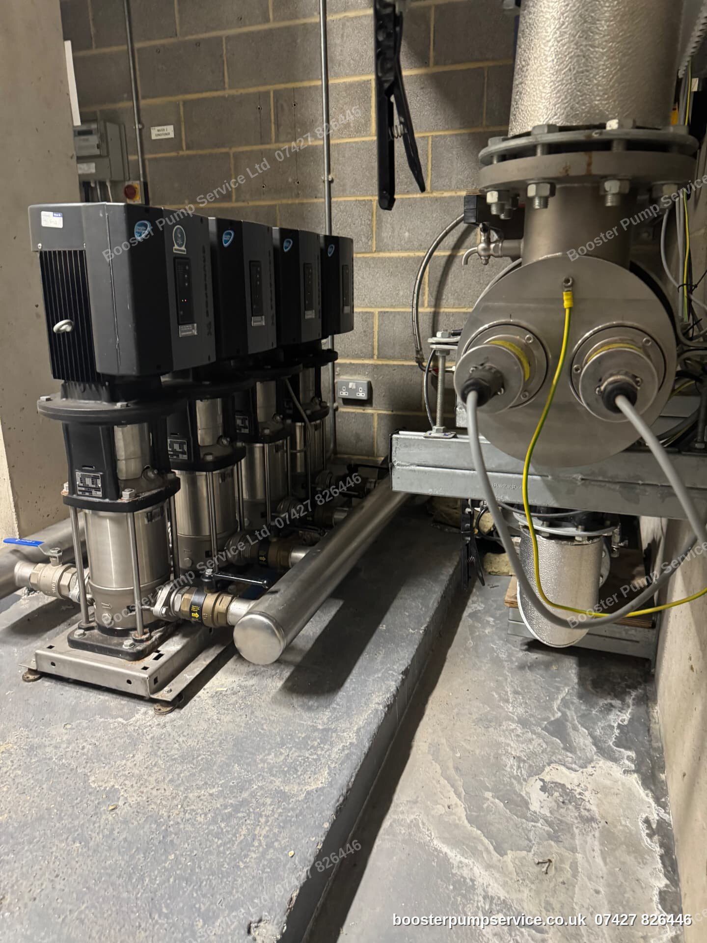 five-pump commercial booster set with stainless manifold and line strainer — booster pump installers in London.
